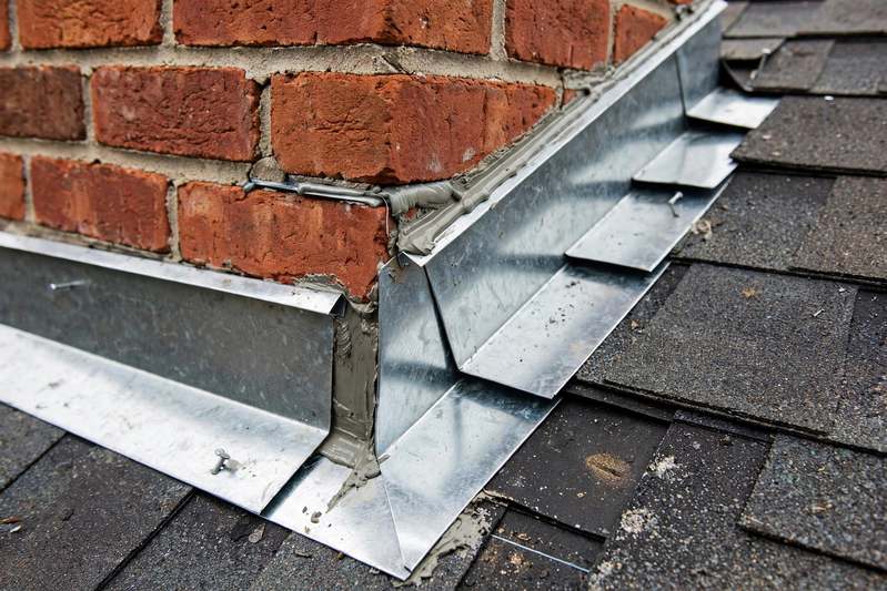 New step and counter flashing around a brick chimney